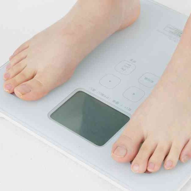 person in bare feet standing on scales