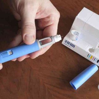 person removing weight loss injection from packaging