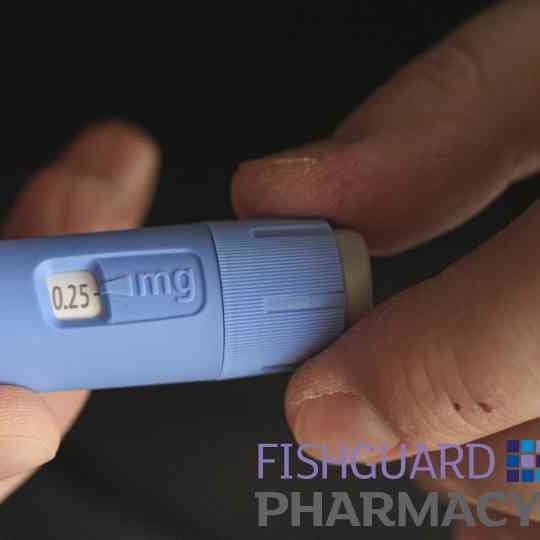 close-up of person holding weight loss injection