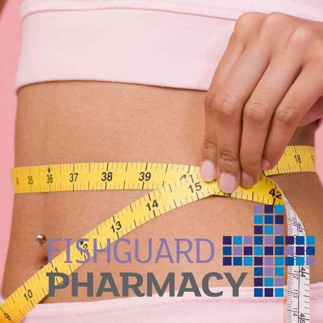 woman in pink workout gear measuring waist